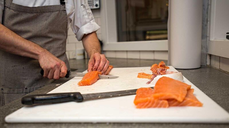 Staff preparing fresh salmon